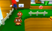 File:Mario salta verso un Goomba.png